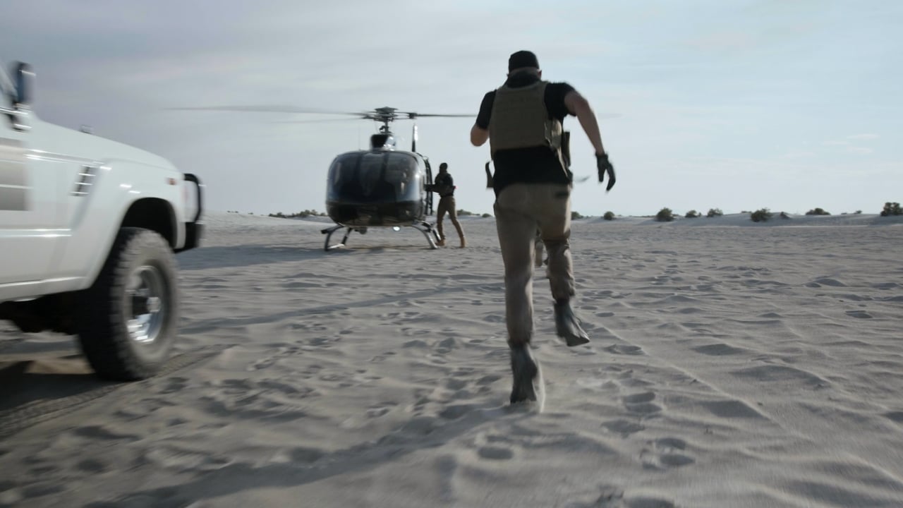 Still from Veterans Stand United: an operator running toward a helicopter in the desert